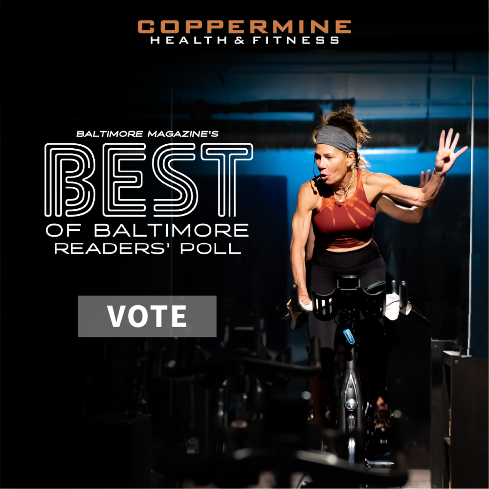 Image of Woman Leading a Spin Class in Cycle Studio. Coppermine Logo Superimposed at top of image. Superimposed text reads: "Baltimroe Magazine's Best of Baltimore Reders' Poll. Vote"